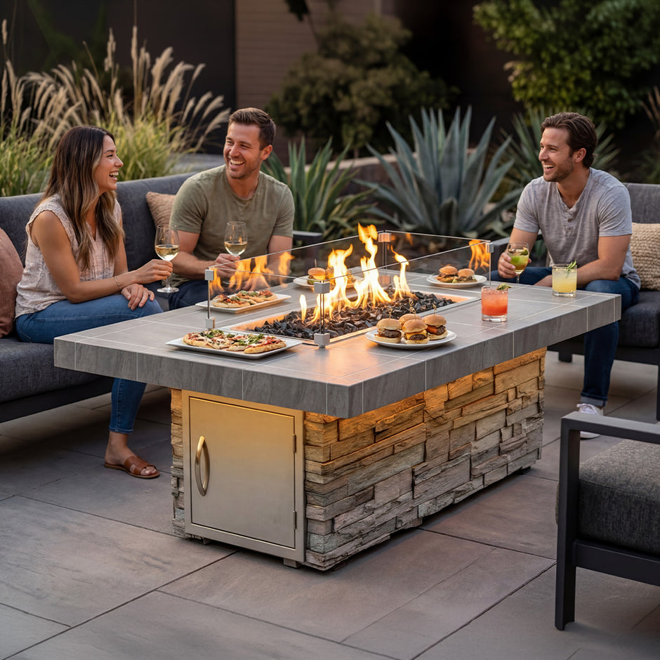 People gathering around a stone fire table in a furnished outdoor living space